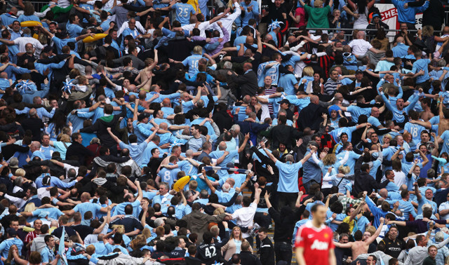 Man City fans doing the Poznan during the Manchester Derby