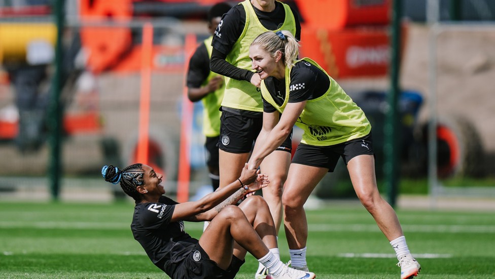 HELP IS AT HAND : Laura Coombs helps Kerolin Nicoli off the turf