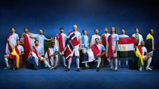 Group of 16 people wearing Manchester City kits, each with a different national flag draped over their shoulders, standing against a blue background.