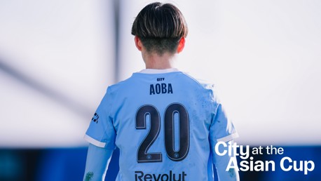Player Aoba wearing a jersey with number 20 at the Asian Cup, featuring City logo and Revolut sponsor branding.