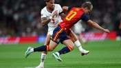Two players from England and Spain competing in a match. The English player wears a white jersey with number 3, and the Spanish player wears red with number 10.