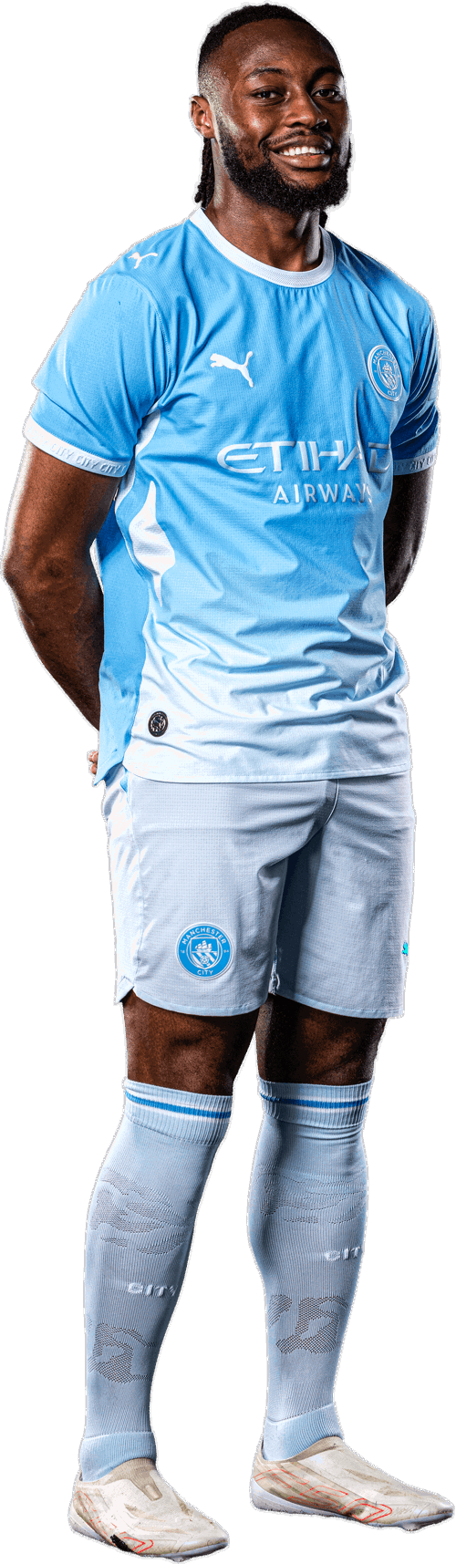 A person wearing a Manchester City football kit, consisting of a light blue jersey with 'Etihad Airways' sponsor logo, shorts with Manchester City logo, and football boots.