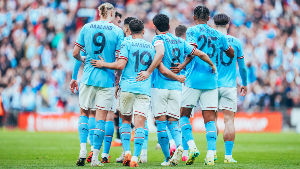 ONE TEAM : City players celebrate the opening goal together. 