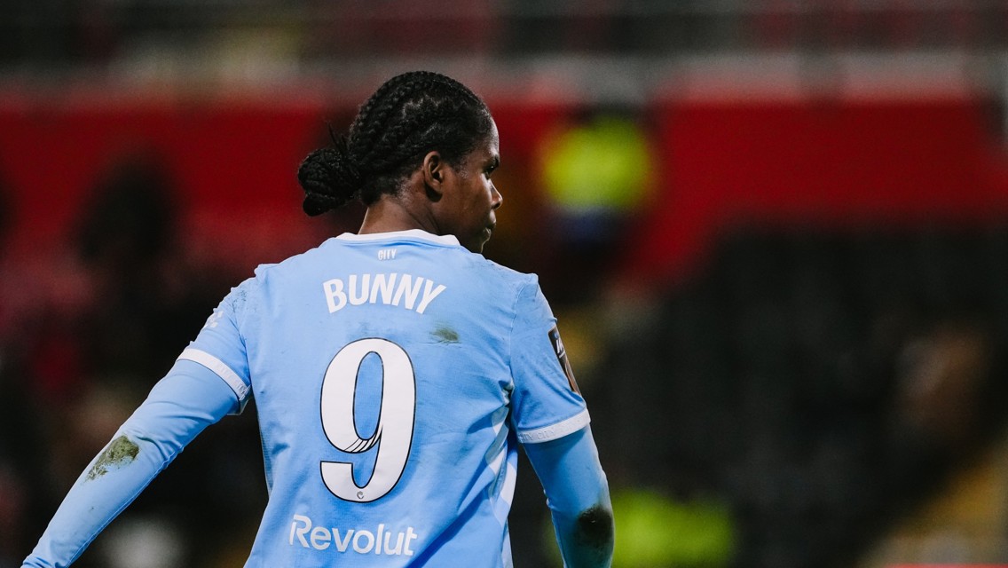 A football player wearing a light blue jersey with the name 'Bunny' and number 9 on the back, during a match.