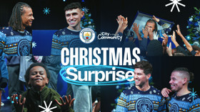 Collage of people wearing Manchester City Christmas sweaters, with a Christmas tree and gifts, under 'Christmas Surprise' text. Manchester City and 'City in the Community' logos are visible.