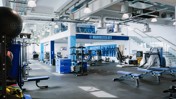 Manchester City gym facility with workout equipment, medicine balls, benches, and blue accents.