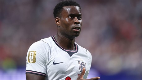 A football player wearing an England national team jersey with a FIFA World Cup 2026 patch on the sleeve.