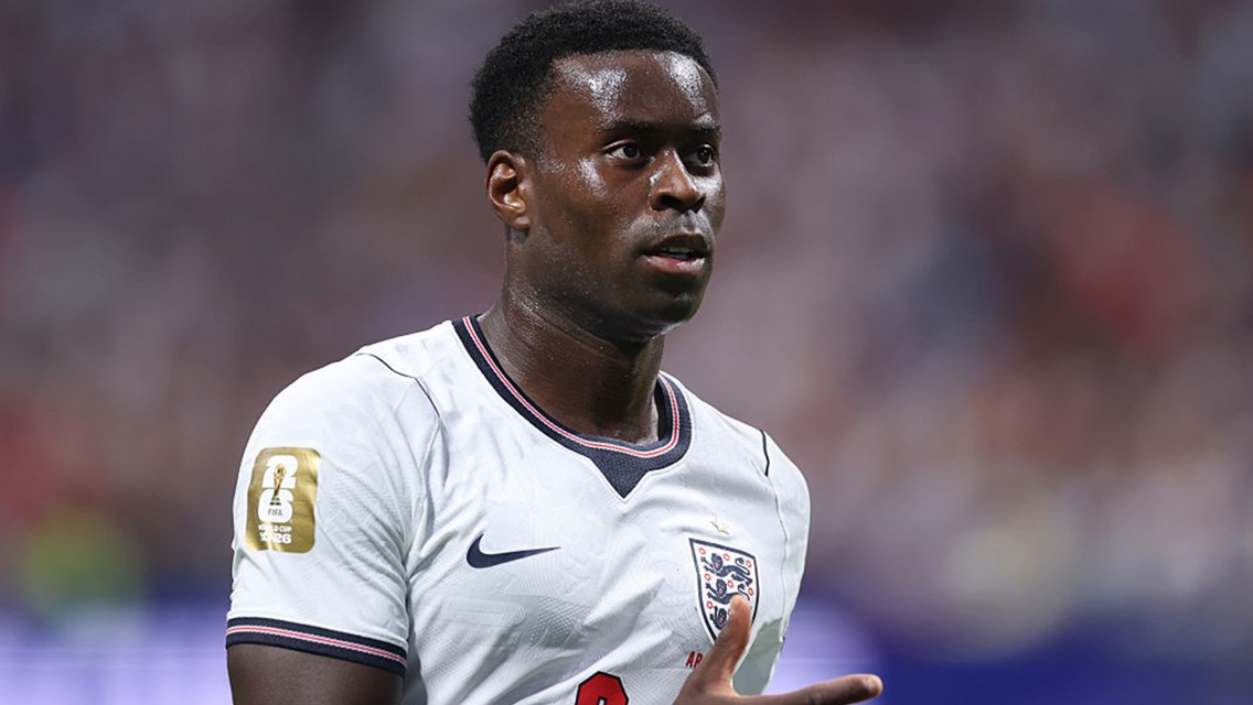 A football player wearing an England national team jersey with a FIFA World Cup 2026 patch on the sleeve.