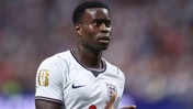 A football player wearing an England national team jersey with a FIFA World Cup 2026 patch on the sleeve.