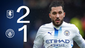 Football match result graphic with Aston Villa and Manchester City logos, showing a 2-1 victory for Aston Villa. A player in a Manchester City kit is prominently featured.