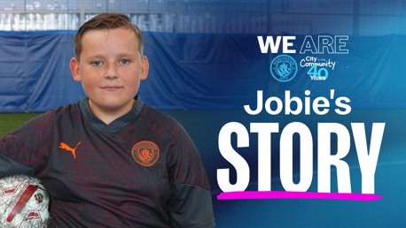 A young boy wearing a Manchester City shirt poses with a football. The text 'We Are City in the Community 40 Years' and 'Jobie's Story' is on the image.