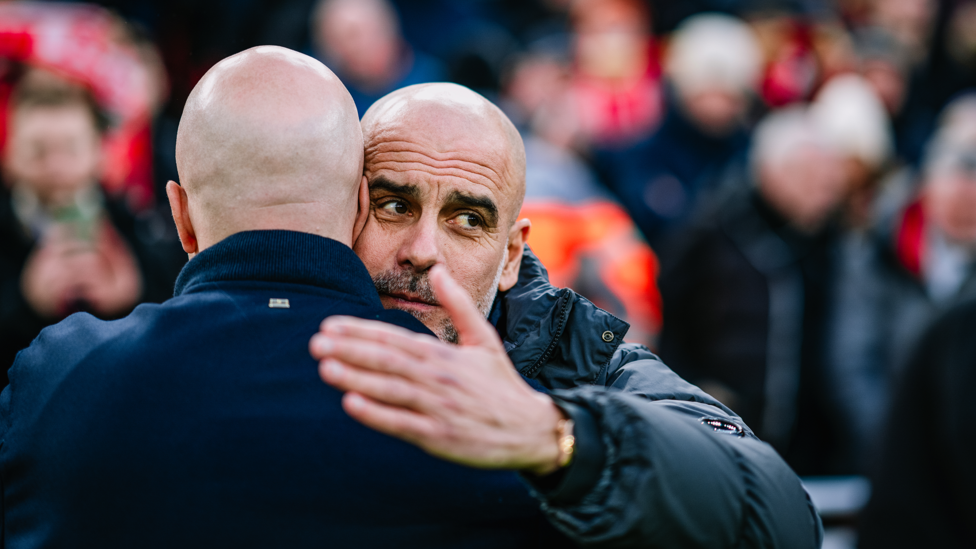 BOSSES : Guardiola and Slot share a warm embrace ahead of kick-off.