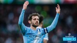 Football player in Manchester City kit celebrating with hands raised, blue captain armband, text 'Carabao Cup Winners 2026' on image.