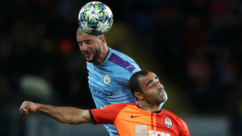UP AND AT EM : Kyle Walker rises to head clear