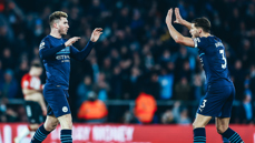 DEFENSIVE DUO: Dias celebrates with Laporte after the equaliser.