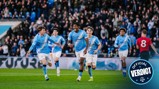 Manchester City players celebrate a goal in blue jerseys while opposing player in red jersey reacts. Official Verdict logo in corner.