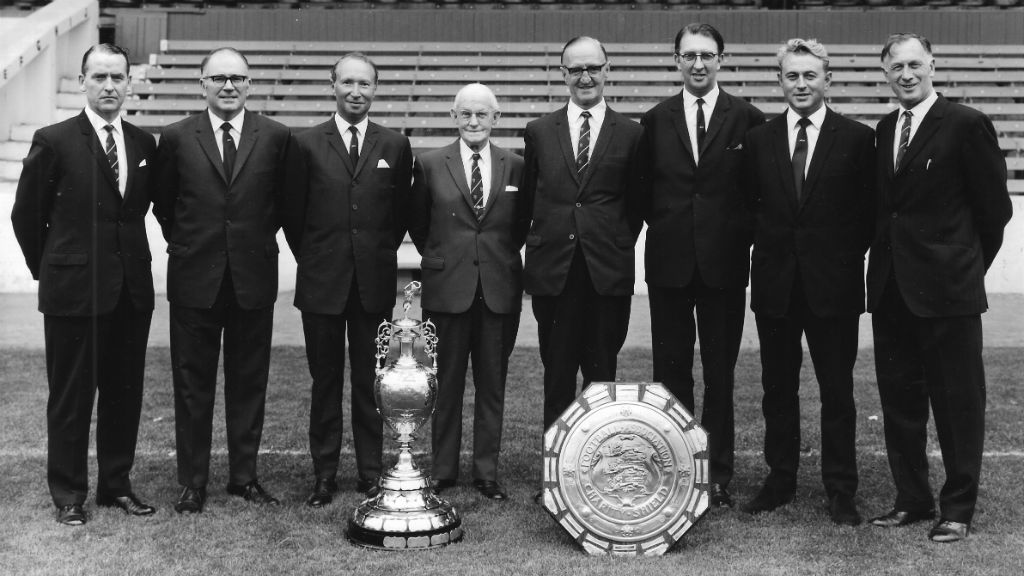 ALL SMILES : Joe (far right) proudly poses with the City directors - along with the Division One trophy and Charity Shield