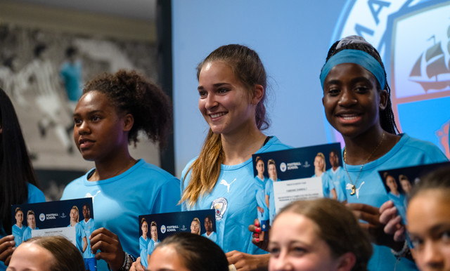 Female players showing their certificates