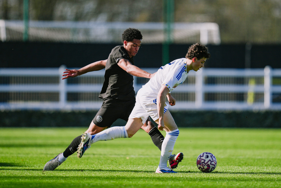 DEFENSIVE DUTIES : Leke Drake puts in a vital tackle.