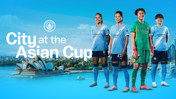 Four football players in Manchester City kits stand in front of a skyline featuring the Sydney Opera House, promoting 'City at the Asian Cup'.