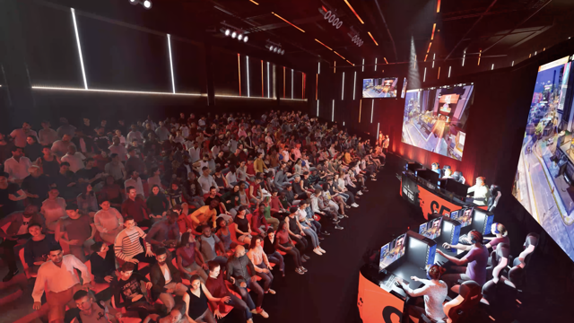 Large audience watching an esports tournament, with players in gaming chairs and large screens displaying gameplay.