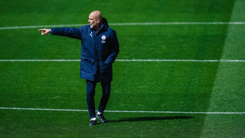 POINTING THE WAY: Manager Pep Guardiola lines up the next drill.