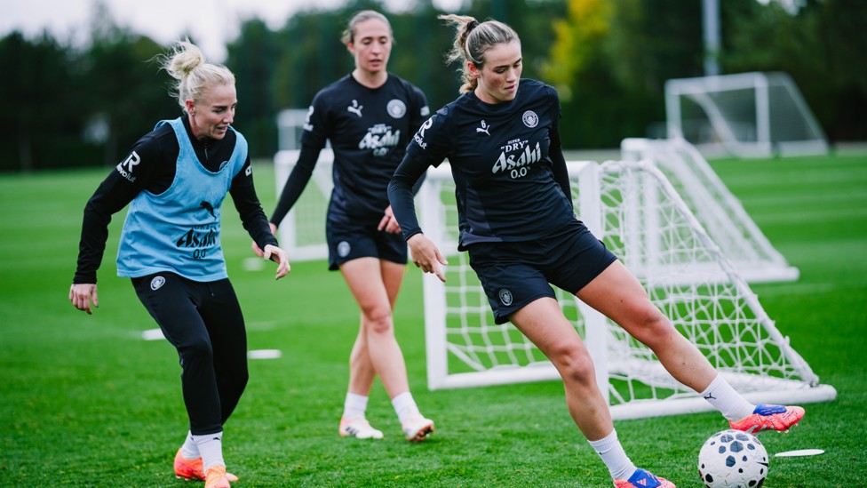 TOUCH TIGHT : Alex Greenwood keeps an eye on Grace Clinton