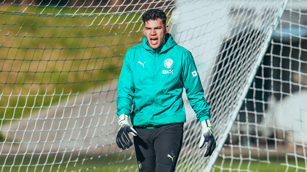 AUTUMN'S COMING : Ederson wraps up as the weather cools in Manchester