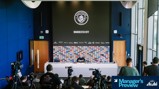 Press conference room at Manchester City with logo and sponsors in the background, chairs and media equipment set up for Manager's Review event.