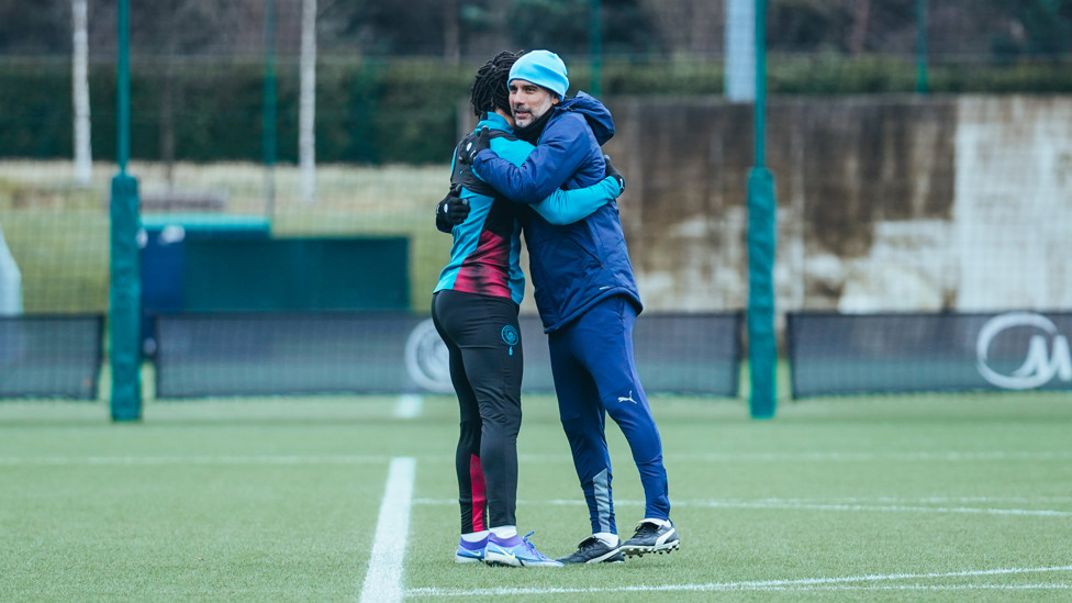 BRING IT IN : Nathan Ake and Pep Guardiola embrace