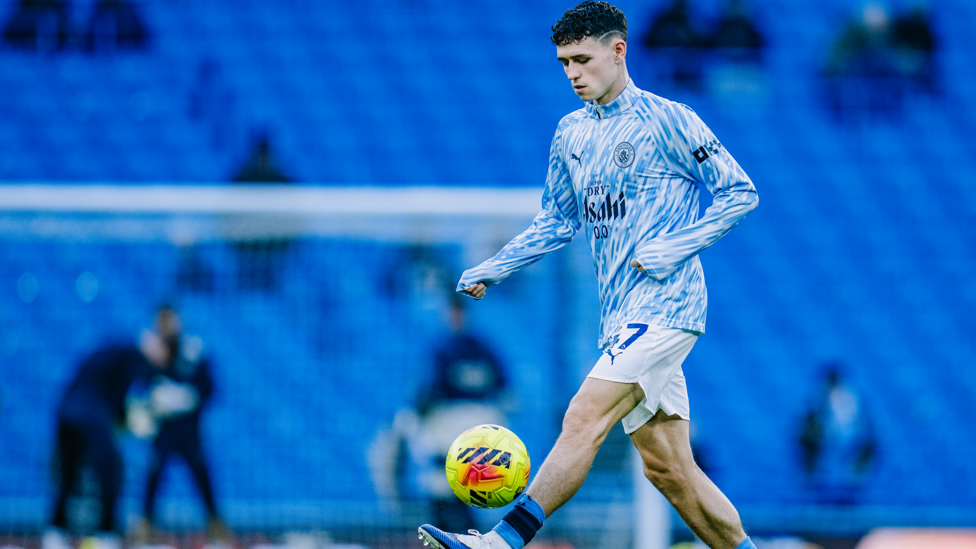 PHIL-ING GOOD : Foden gets in the mood during the pre-match warm up.