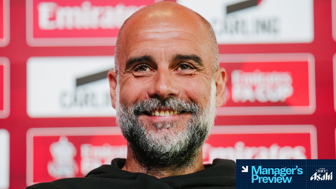 Blurred face at a press conference backdrop mentioning 'Emirates FA Cup'.