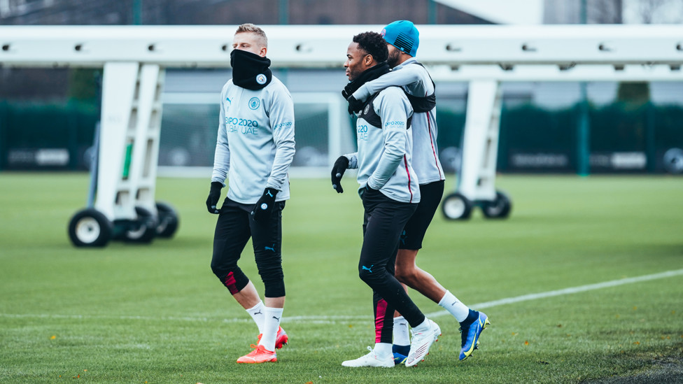 LIMBERING UP : Oleks Zinchenko, Riyad Mahrez and Raheem Sterling make their way out onto the training pitch.