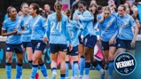 A group of Manchester City Women's team players in light blue jerseys celebrating during a match.