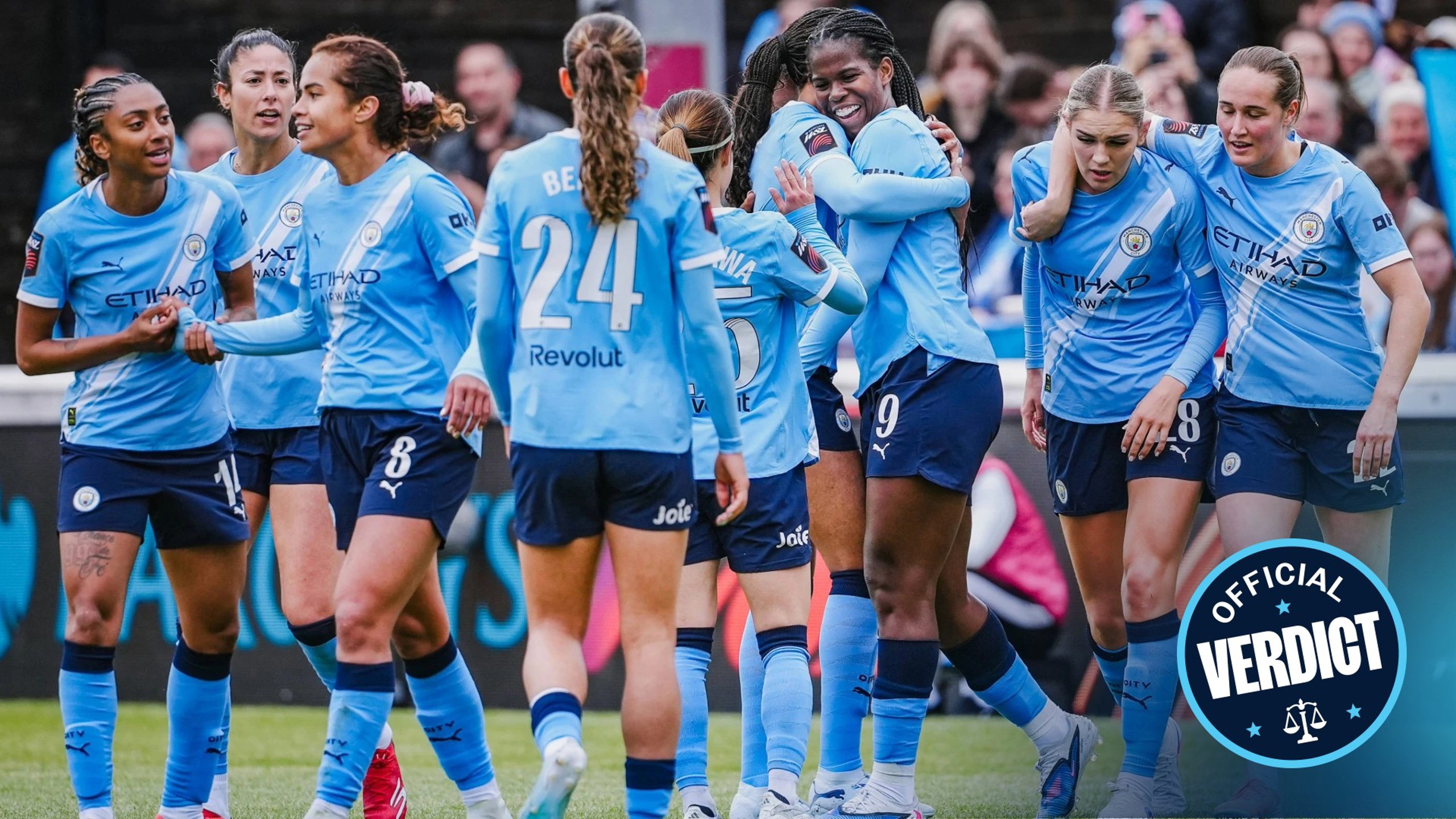 A group of Manchester City Women's team players in light blue jerseys celebrating during a match.