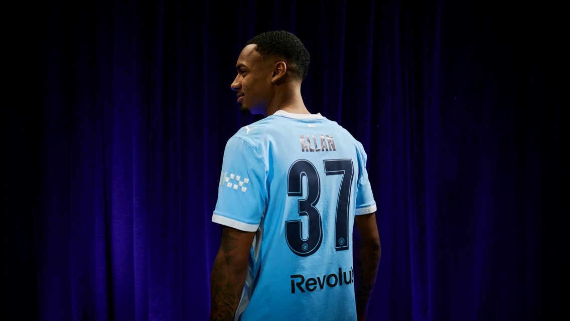 A person wearing a light blue football jersey with the name 'ALAN' and number 37, featuring Manchester City branding and Revolut sponsorship.