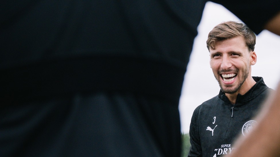 TIME TO TALK : Ruben Dias laughs as the team gather around