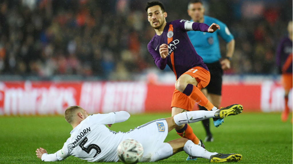 SKIP TO IT: David Silva evades the challenge of Swansea's Mike van der Hoorn