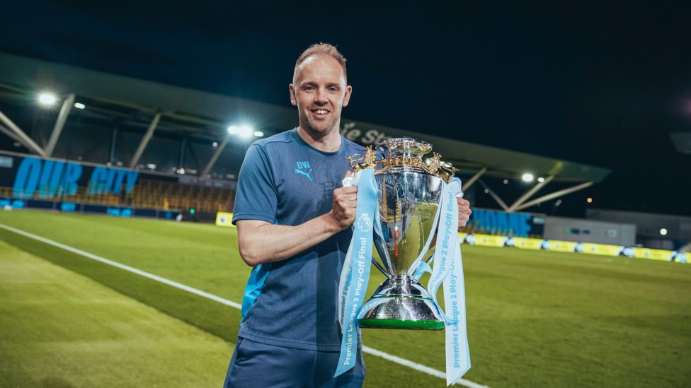 THE BOSS : Elite Development Squad Lead Coach Ben Wilkinson poses for a picture with our PL2 trophy. 