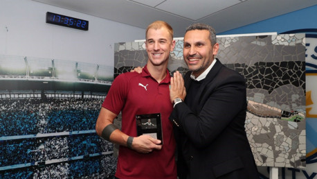 SPECIAL TRIBUTE: Manchester City chairman Khaldoon Al Mubarak presents Joe Hart with a lifetime seasoncard and special replica mosaic