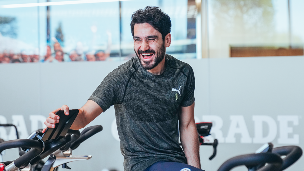 GLORIOUS GUNDO : Ilkay has a laugh while warming up on a bike