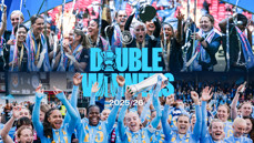 Manchester City celebrates winning two titles in the 2025/26 season with players lifting the trophies. The image includes banners and blurred faces with the text 'Double Winners' prominently displayed.