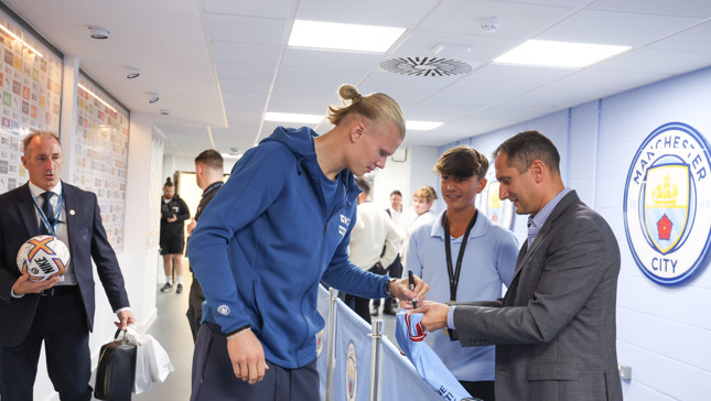 Image of Haaland signing shirt on the Champion Experience - hospitality
