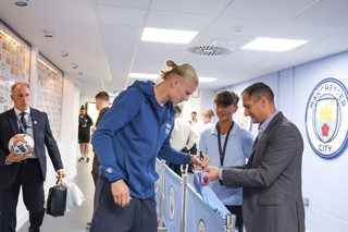 Image of Haaland signing shirt on the Champion Experience - hospitality