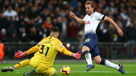 BLOCK: Ederson stops Harry Kane in his tracks as he charges towards goal.