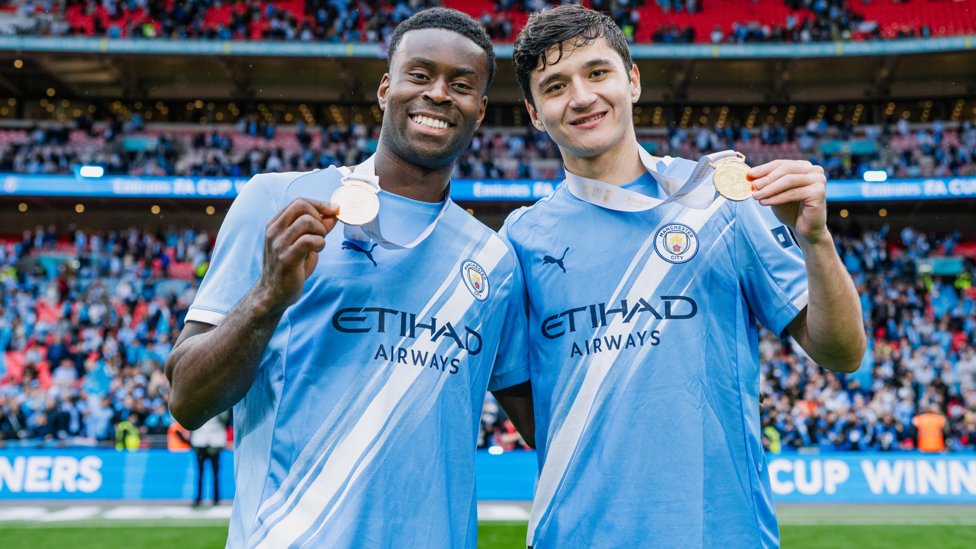DEFENSIVE DUO : Our solid partnership show off their medals.