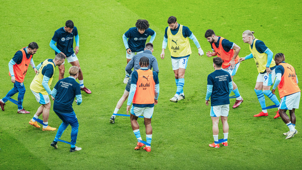 GET LOOSE : The players go through their pre-match stretches.
