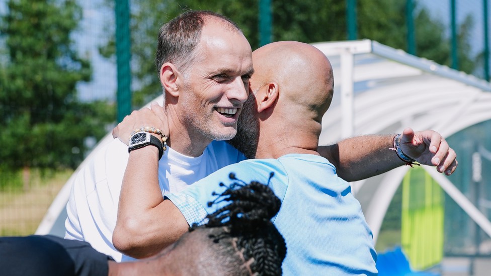 WARM WELCOME : Pep Guardiola and Thomas Tuchel catch up at training. 