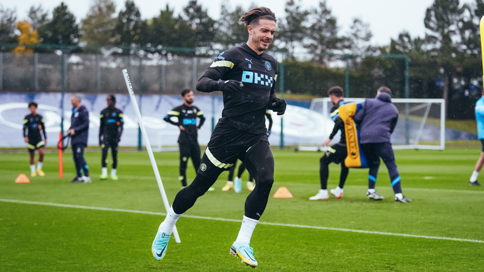 WHY DOES IT ALWAYS RAIN ON ME : Jack Grealish embracing the Manchester weather.