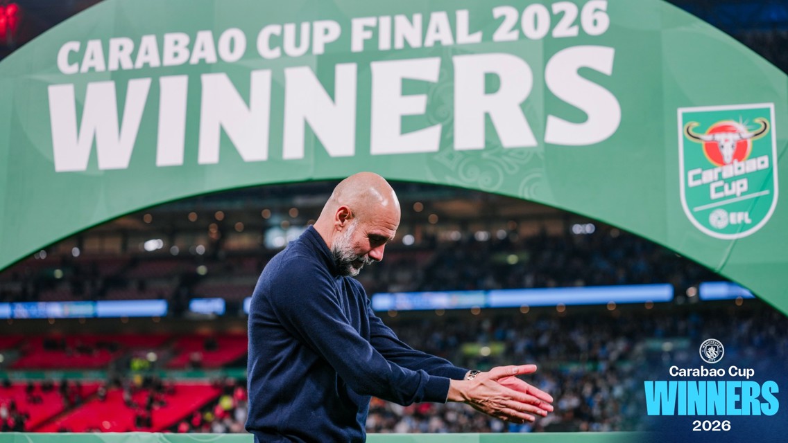 A person clapping in front of a large sign reading 'Carabao Cup Final 2026 Winners'.